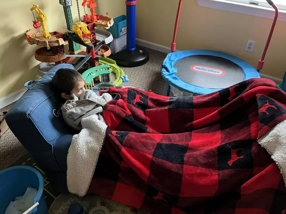 Poor little Griffin fighting his cold with rest, fluids, a little bit of TV, and a nice warm blanket. (Dan Zarrow, Townsquare Media)
